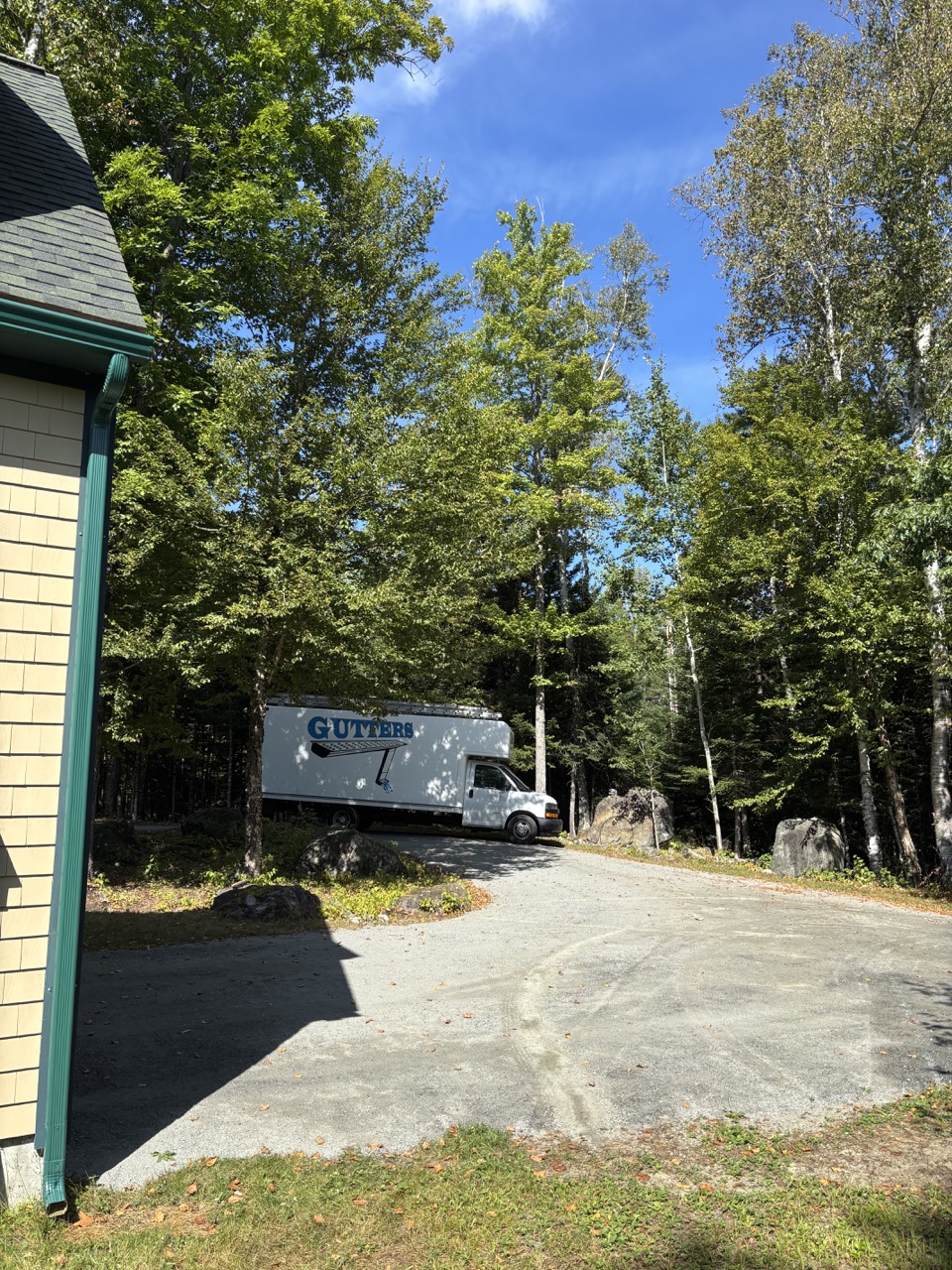 Crown Hill Gutter Company truck parked in New England pine forest